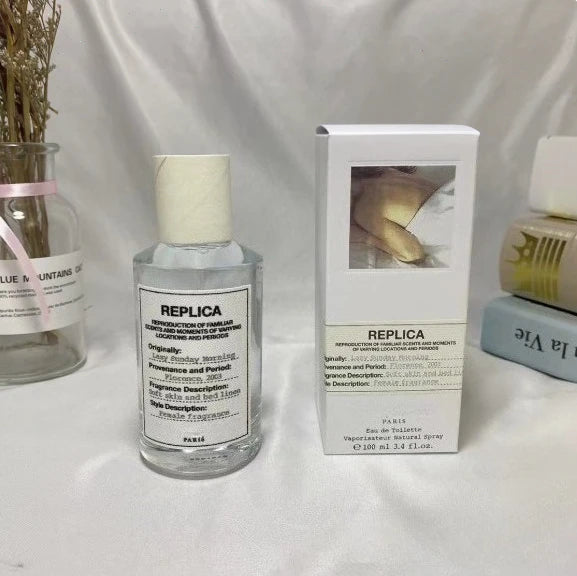 White box with 'REPLICA' label next to a 100ml Unisex Pheromone Perfume by theelegancejewellery on a plain white surface.