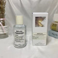 White box with 'REPLICA' label next to a 100ml Unisex Pheromone Perfume by theelegancejewellery on a plain white surface.