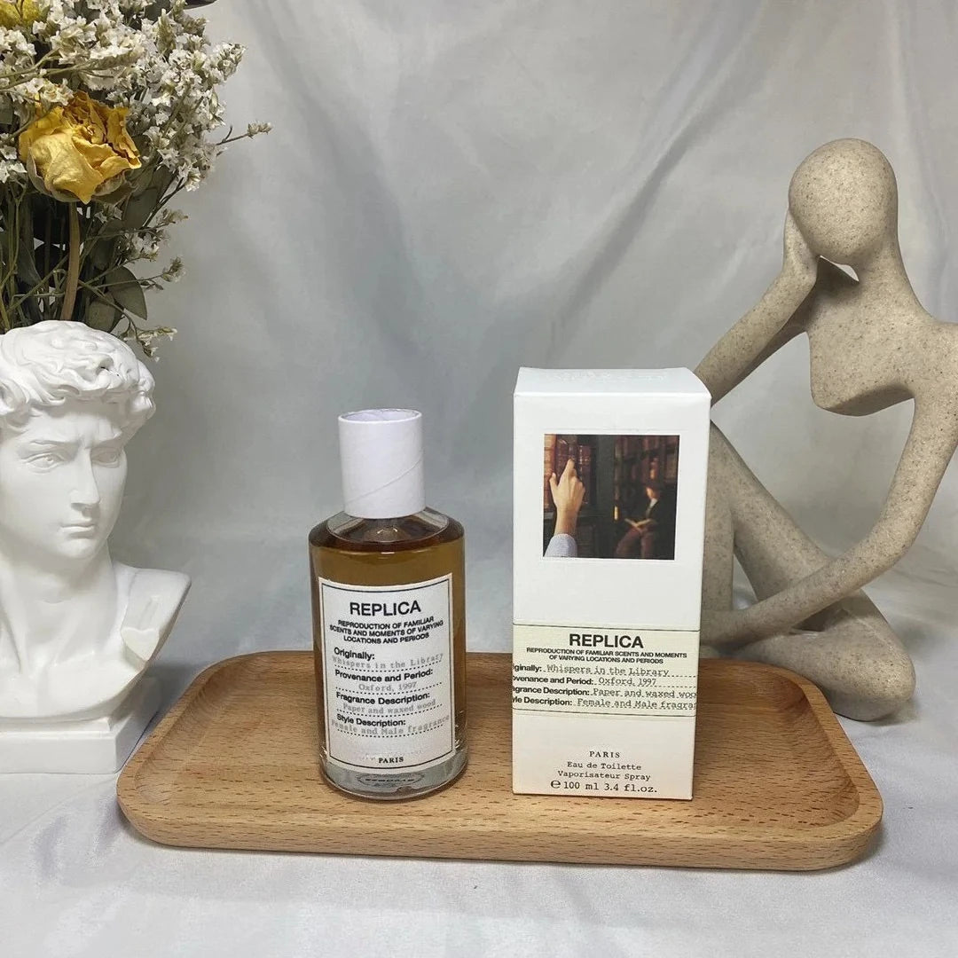 Wooden tray with 100ml Unisex Pheromone Perfume bottle and decorative statues next to Replica perfume label