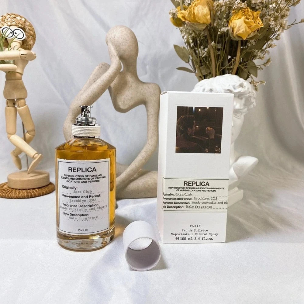 Theelegancejewellery 100ml Unisex Pheromone Perfume bottle with gold cap on white packaging next to a small box containing a floral design